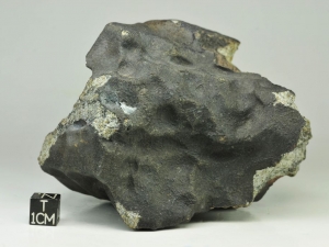 Bassikounou H5 1 kg, fresh regmaglipted specimen with large iron flake on the fusion crust surface